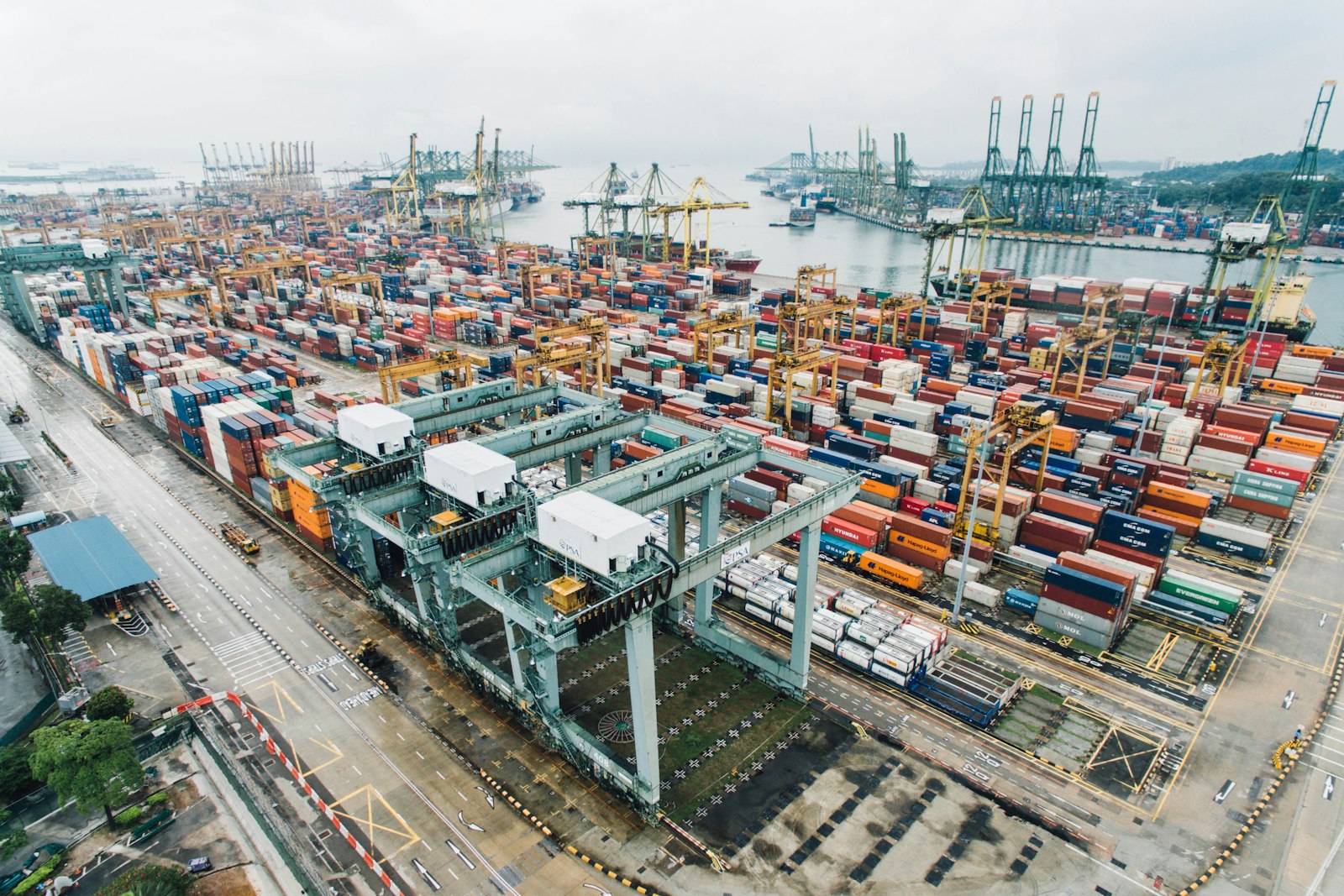 Aerial view of a busy container port terminal with cranes